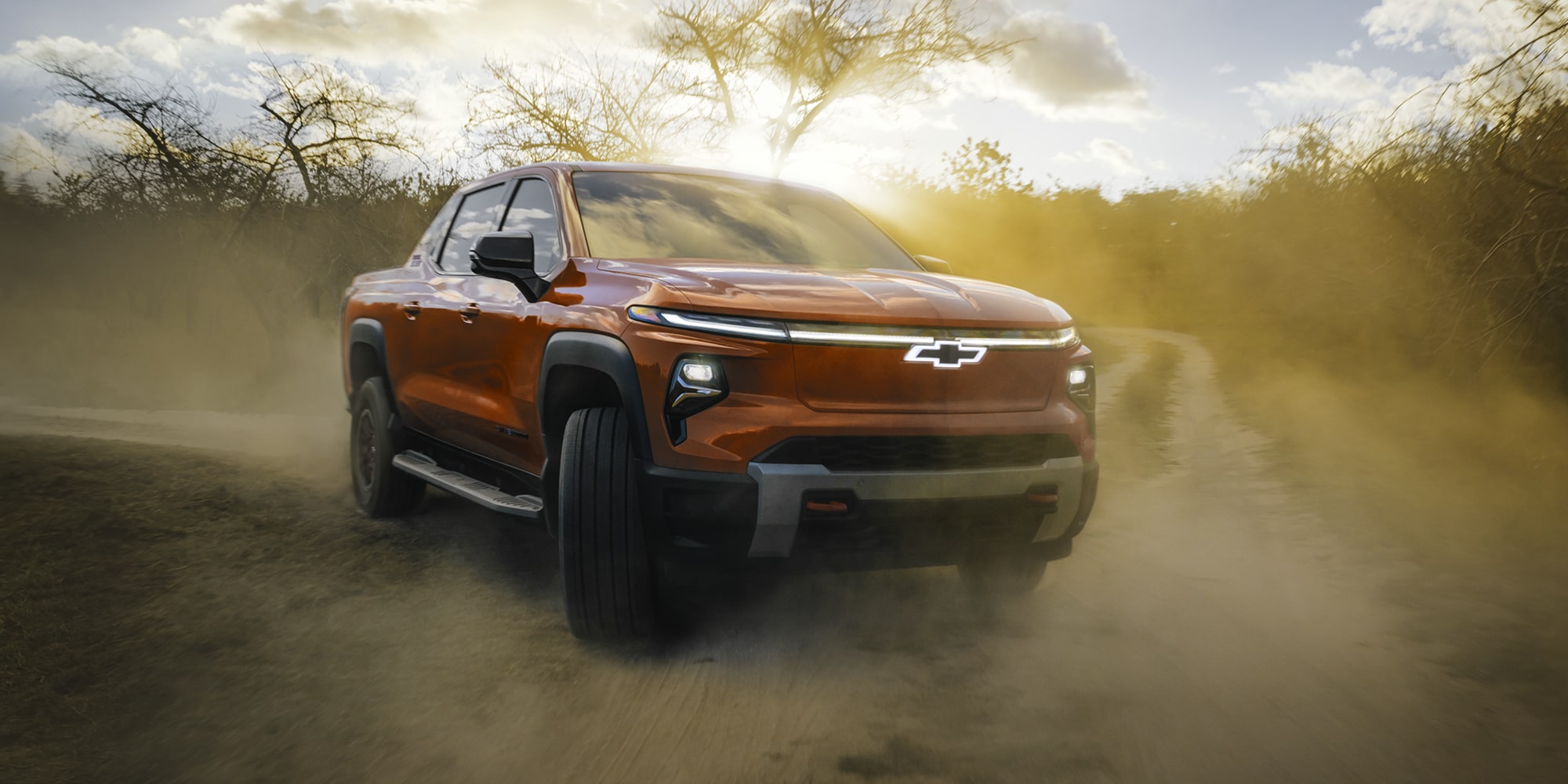 2026 Chevy Silverado EV Driving on a Dirt Road in the Woods