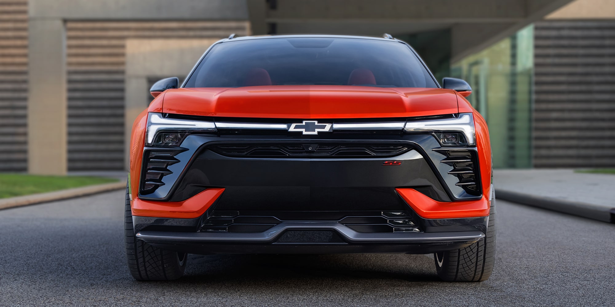 The Front View of a 2027 Chevy Blazer EV SS Showcasing Distinctive LED Lighting, a Sculpted Front Fascia, Black Grille Elements, and the Chevy Bowtie Emblem.