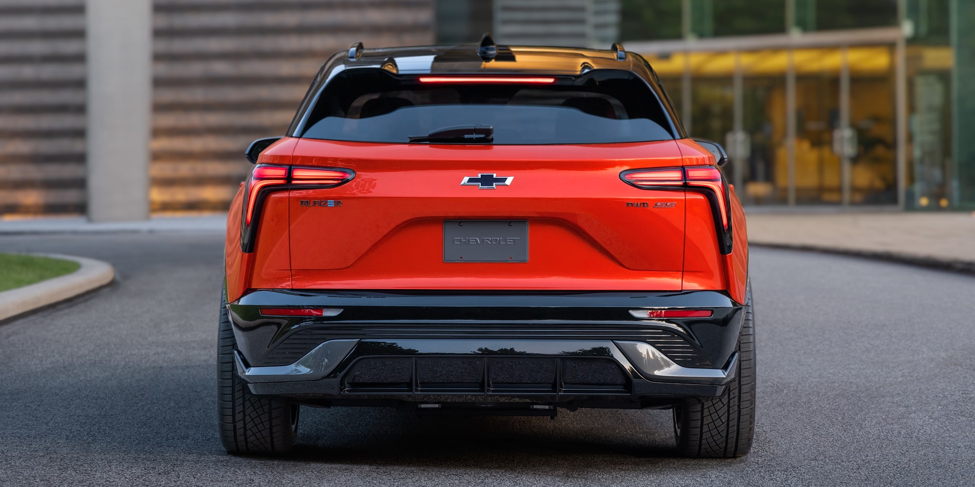 The Rear View of a 2027 Chevy Blazer EV SS Featuring LED Taillights, an Integrated Roof Spoiler, Sculpted Body Panels, and the Chevy Bowtie Emblem Centered on the Liftgate.