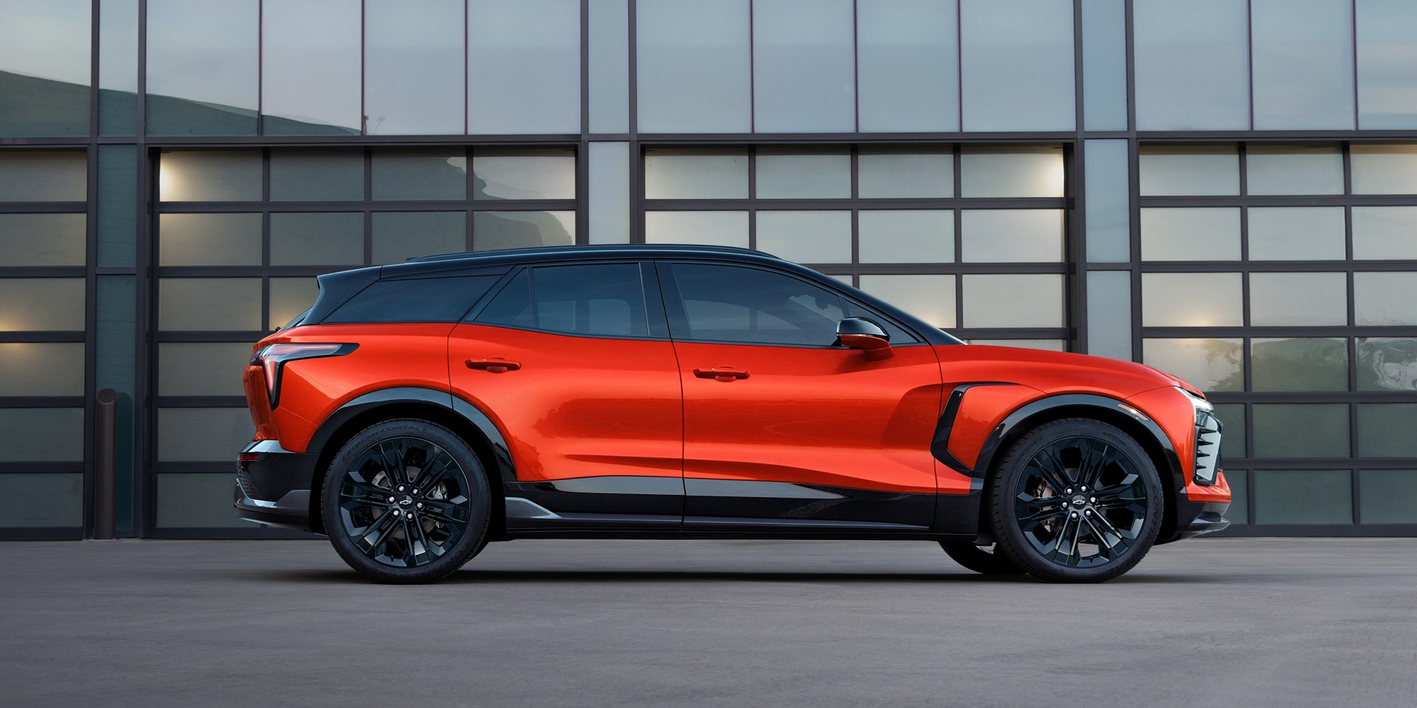 The Side Profile of a 2027 Chevy Blazer EV SS Showcasing Black Alloy Wheels, Athletic Body Lines, a Contrasting Roof, and a Sporty SUV Silhouette.