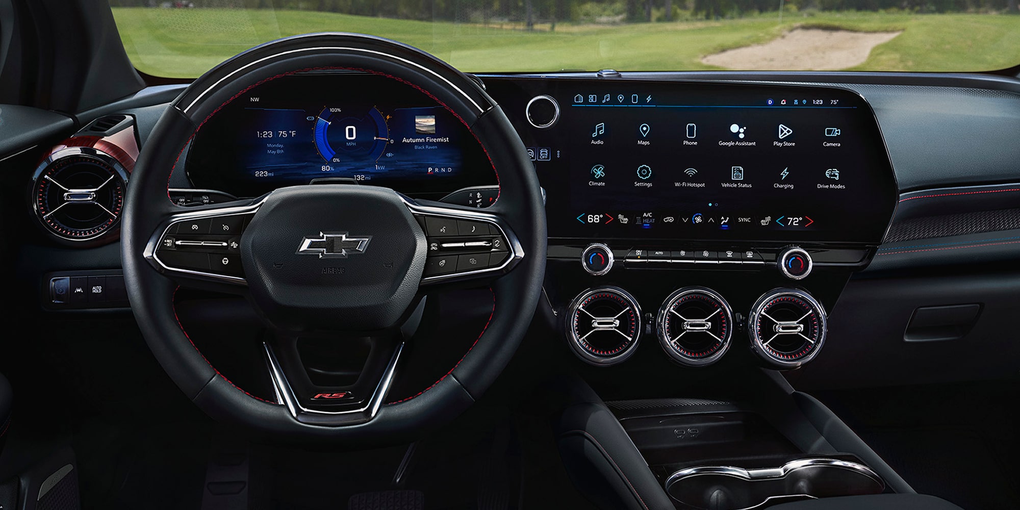 The Interior of a 2027 Chevy Blazer EV Featuring a Multifunction Steering Wheel, Digital Instrument Cluster, Large Infotainment Touchscreen, and Circular Air Vents Across the Dashboard.