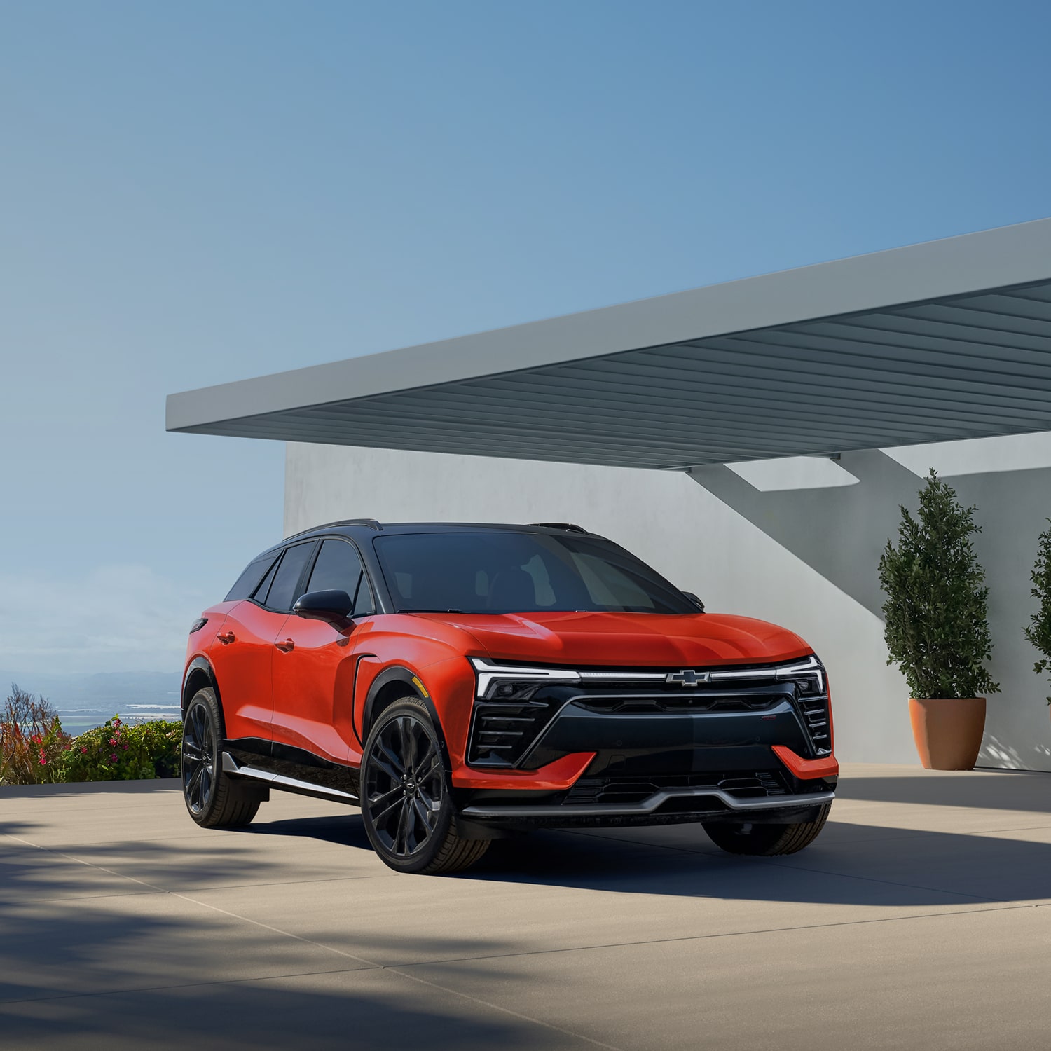 Side Profile View of the 2027 Chevy Blazer EV Parked Under an Awning.