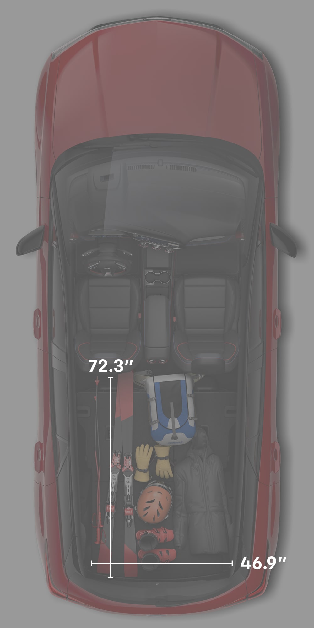 Top-Down View of a Red Chevrolet Blazer EV's Interior Faded, Showing Skis, Boots, a Helmet, and Dimensions