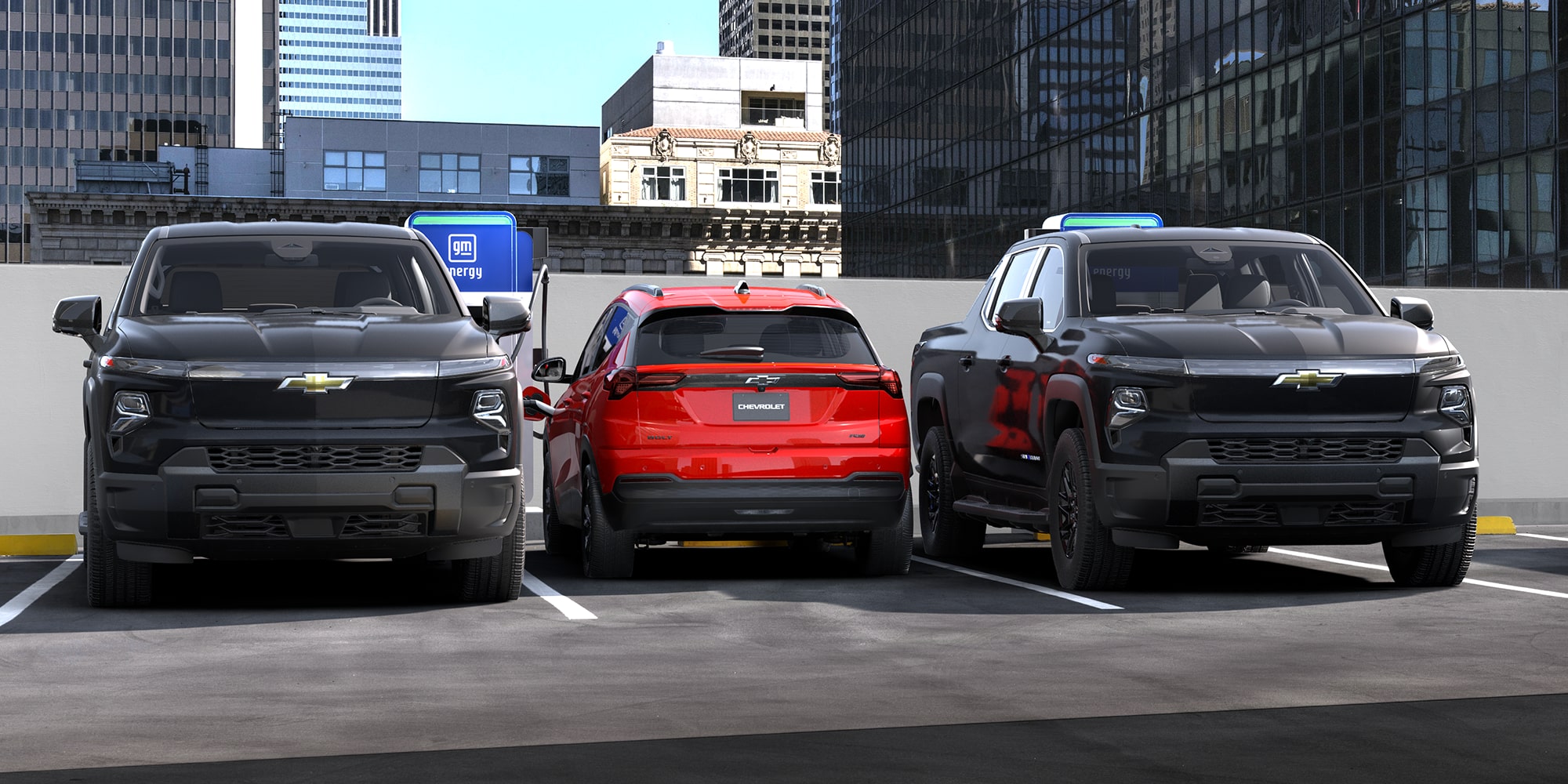 2027 Chevrolet RS in Habanero Parked Between Two Chevrolet Silverado EVs.