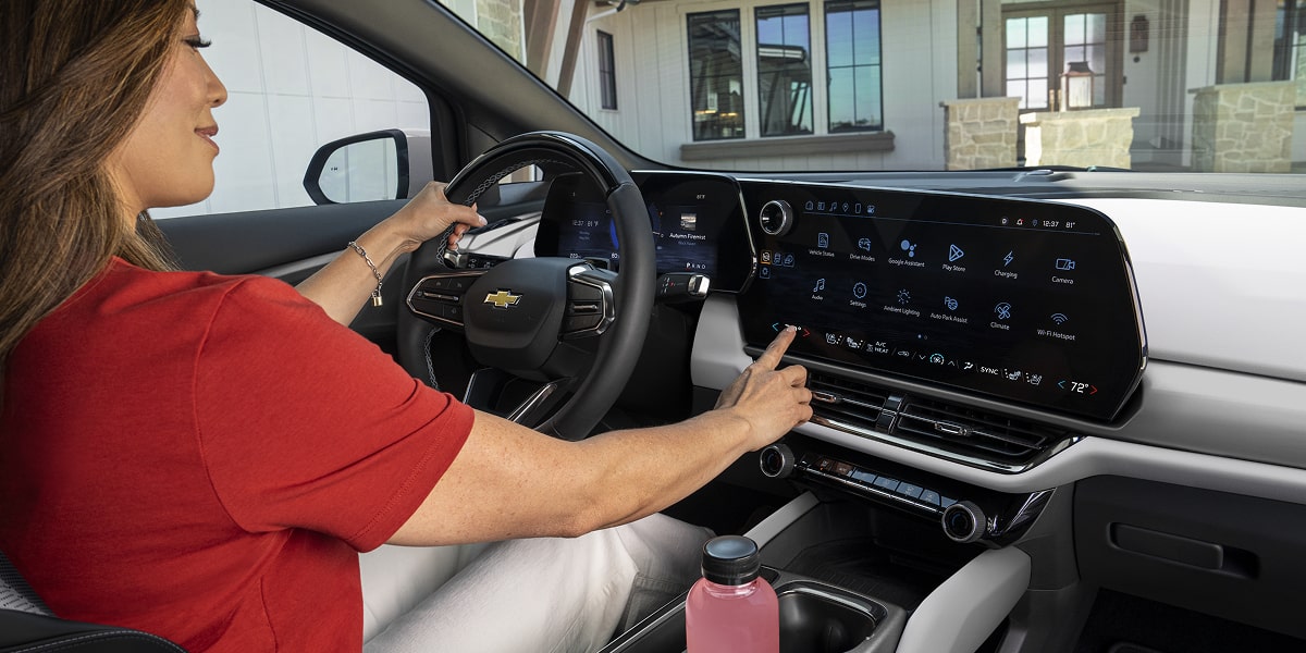 Woman Interacting with the Google Tile Head Unit of Equinox EV