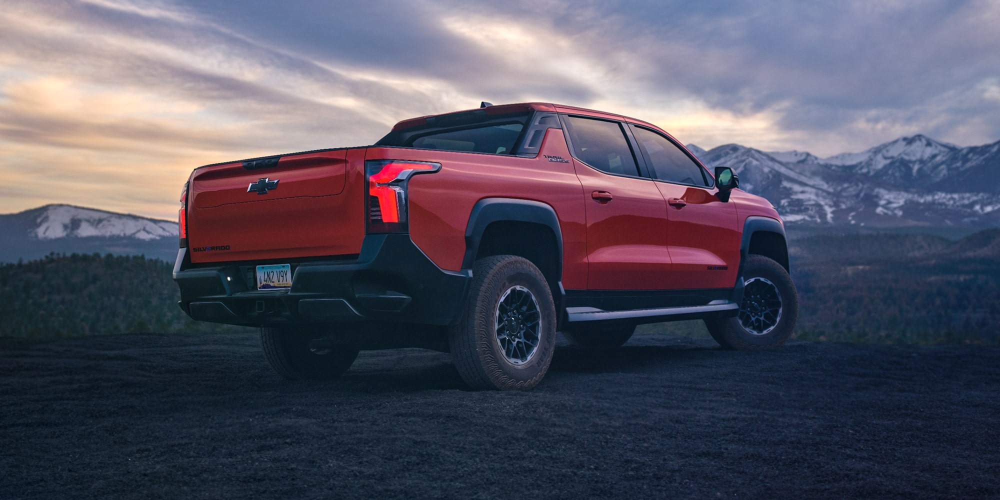 Three Quarters View of an Orange 2026 Chevy Silverado EV in the Middle of a Desert