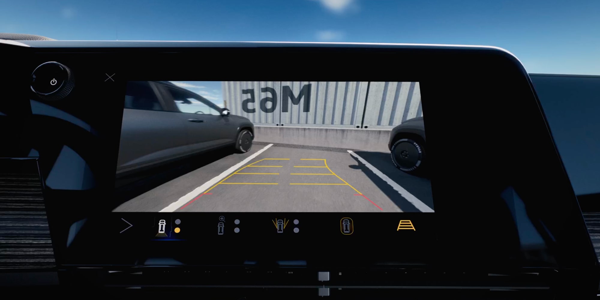 The Chevy Silverado EV Infotainment Display Showing a Rear Camera View With Parking Guidelines While Backing Into a Parking Space.