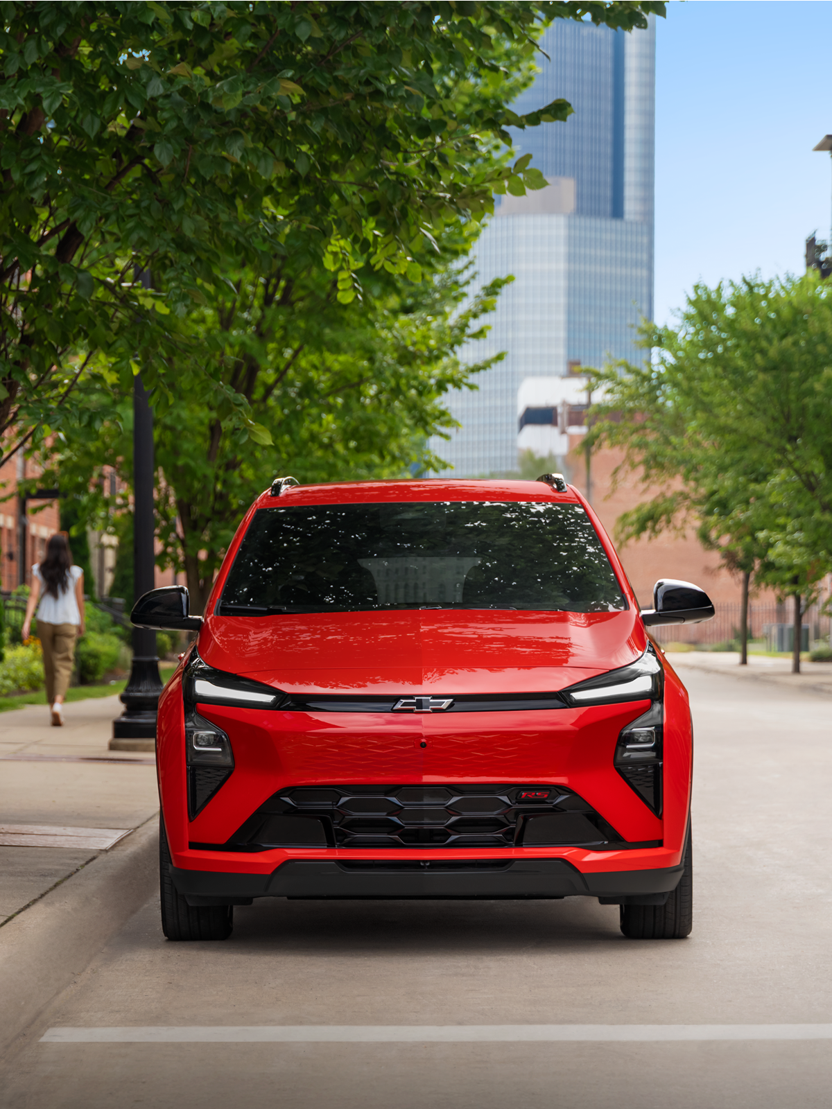 A red 2027 Bolt parked on the street