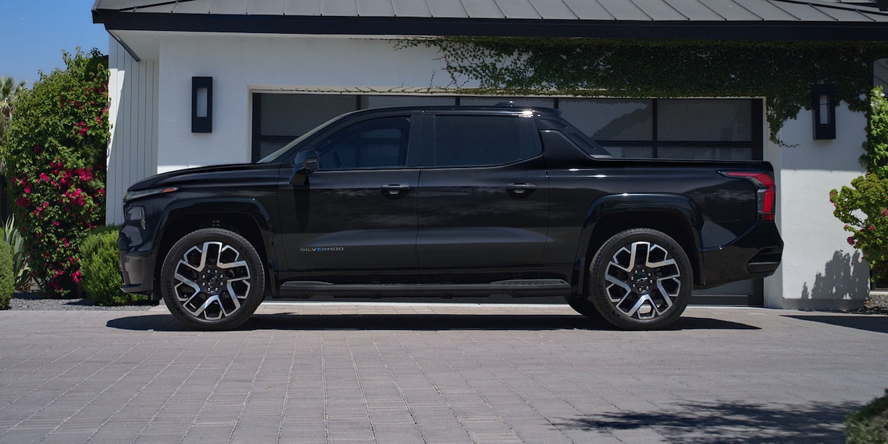 Driver's Side Profile View of a Black Silverado EV Parked in a Driveway