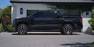 Driver's Side Profile View of a Black Silverado EV Parked in a Driveway