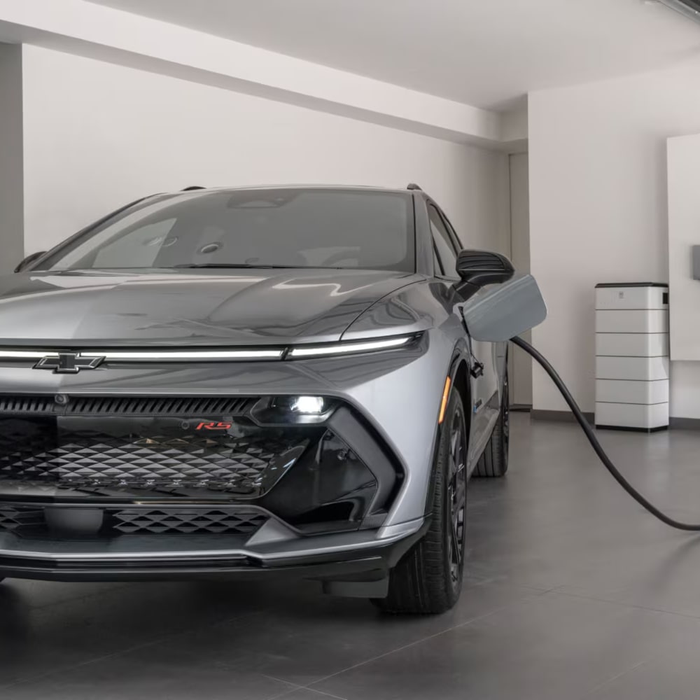 2026 Chevy Equinox EV Plugged into a Wall Charger in a Garage