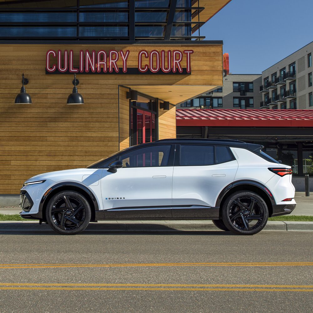2026 Chevy Equinox EV Side Profile Parked Next to a Restaurant