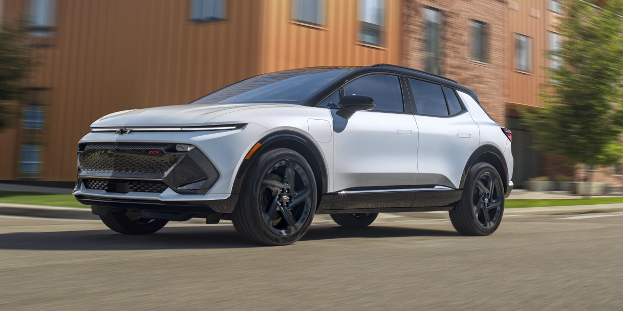 2026 Chevy Equinox EV Driving Past a Storefront