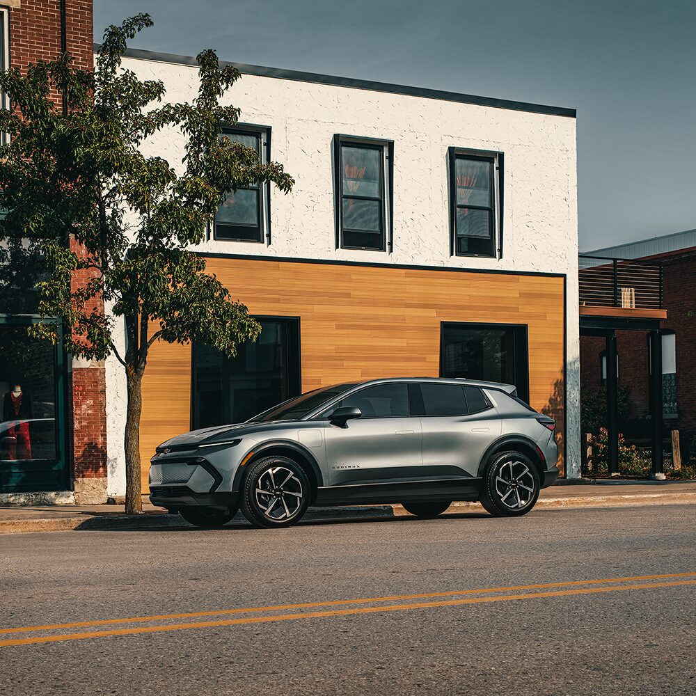 2026 Chevy Equinox EV Side Profile Parked in Front of a Storefront