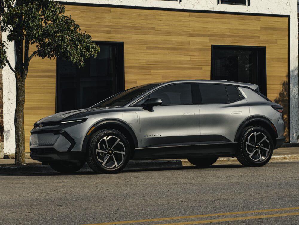 2026 Chevy Equinox EV Side Profile Parked in Front of a Storefront