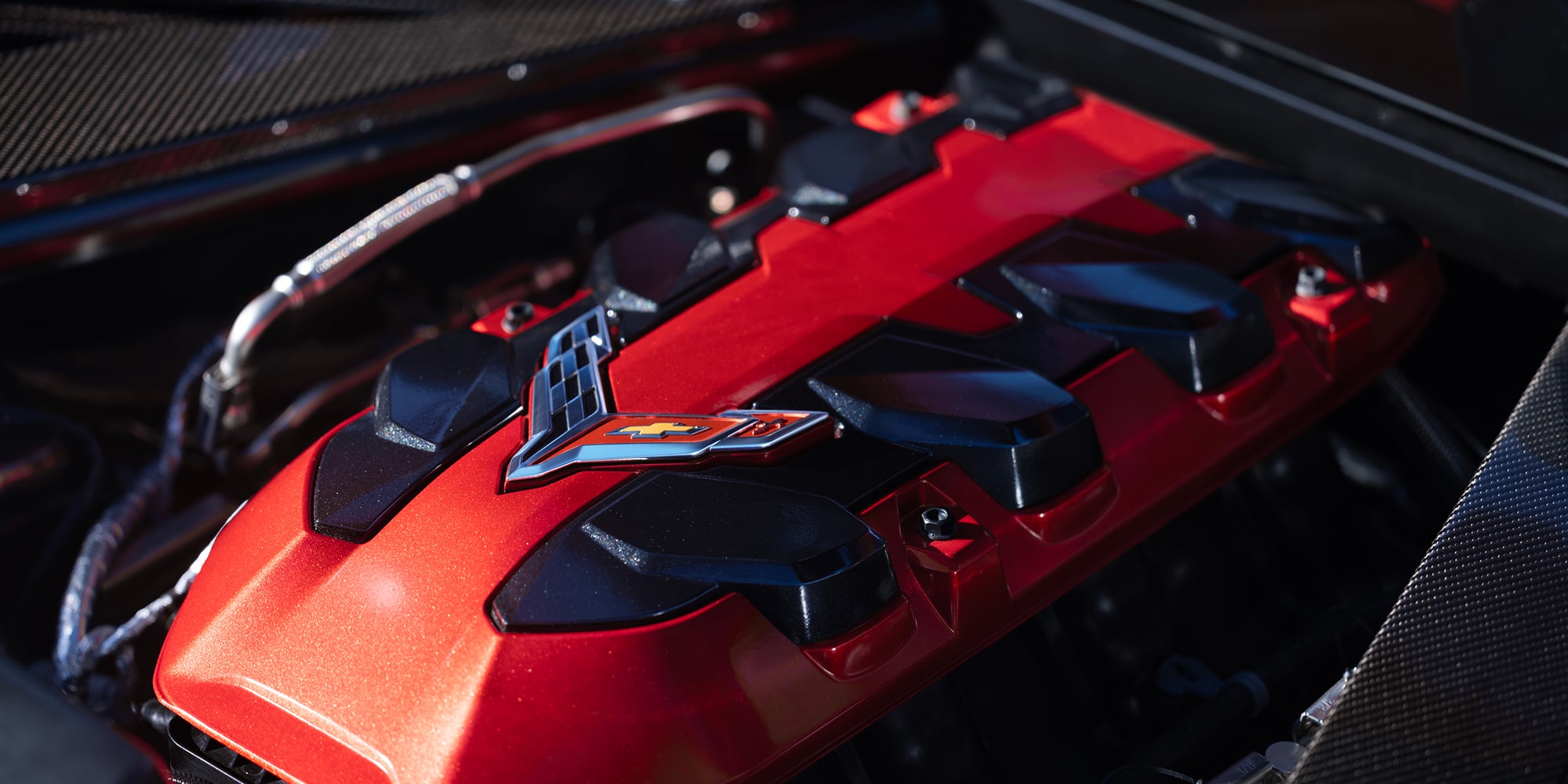 A Corvette Grand Sport Engine Cover With the Corvette Emblem Visible Inside the Engine Bay.