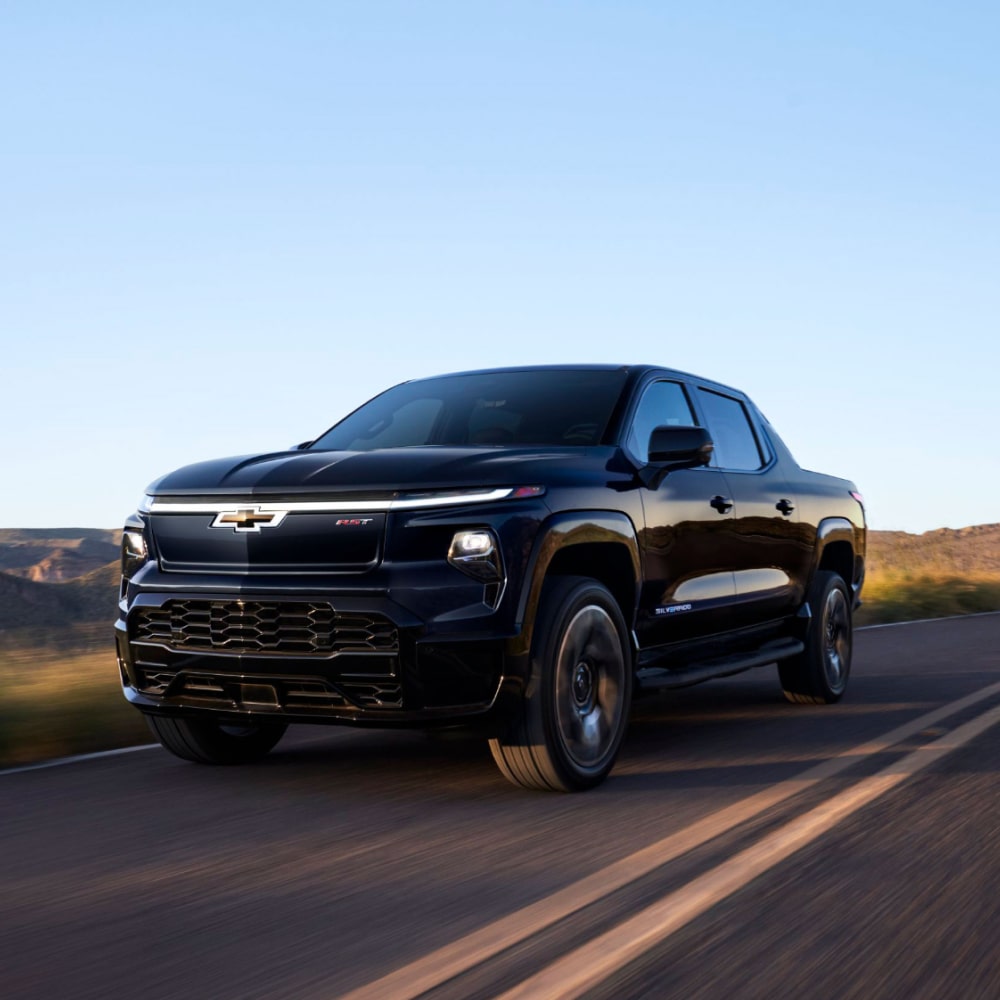 2025 Chevy Silverado EV Driving Down a Western Country Road