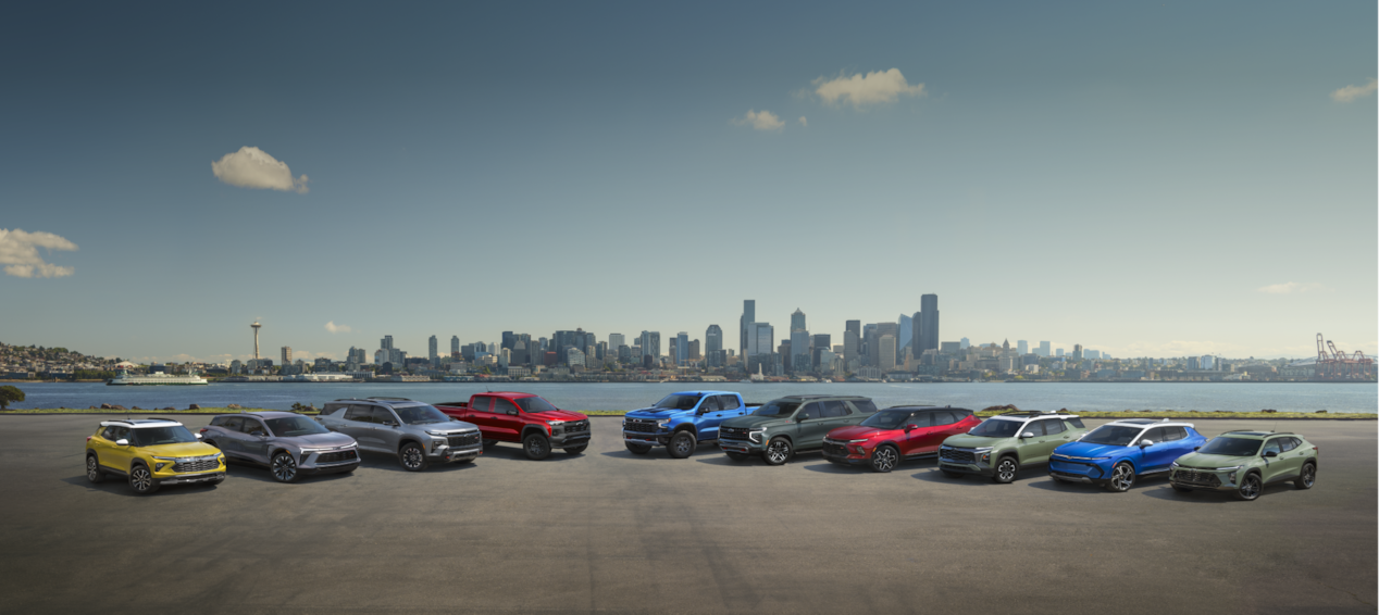 Chevrolet Awards: Chevy's Lineup of Vehicles Parked in Front of a Lake and City Skyline in the Background