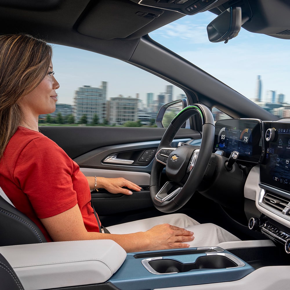 A Woman Using Super Cruise Hands-Free Driving Feature in Her Chevy Vehicle