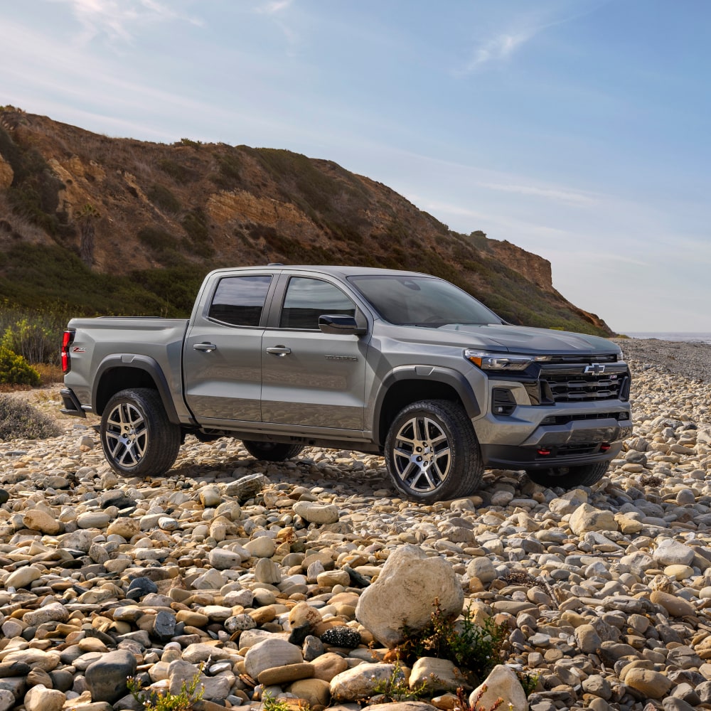 2025 Chevy Silverado 1500 Parked Off-Road on Rocky Terrain with Mountains Nearby