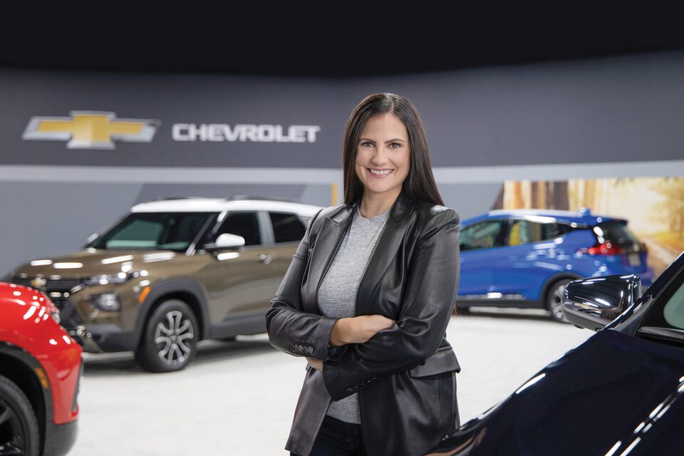 Un especialista en productos sonriendo, parado en un estudio de Chevrolet.