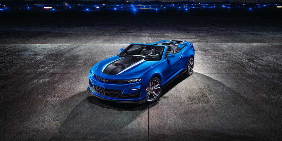 Dark night shot of Dark Blue Camaro parked in open field