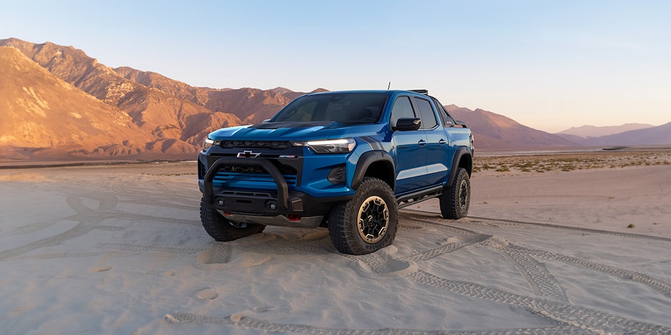 Morning Shot of Blue Colorado with Black roof driving through city road