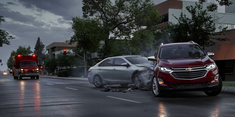 An Ambulance Approaches an Accident During a Rainy Day