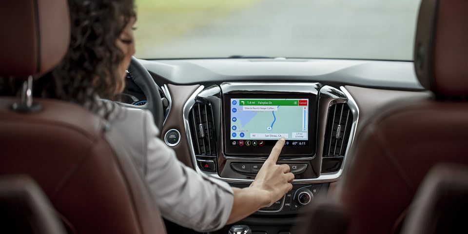 A Woman Uses Google Maps on the Infotainment System of a Chevy Vehicle