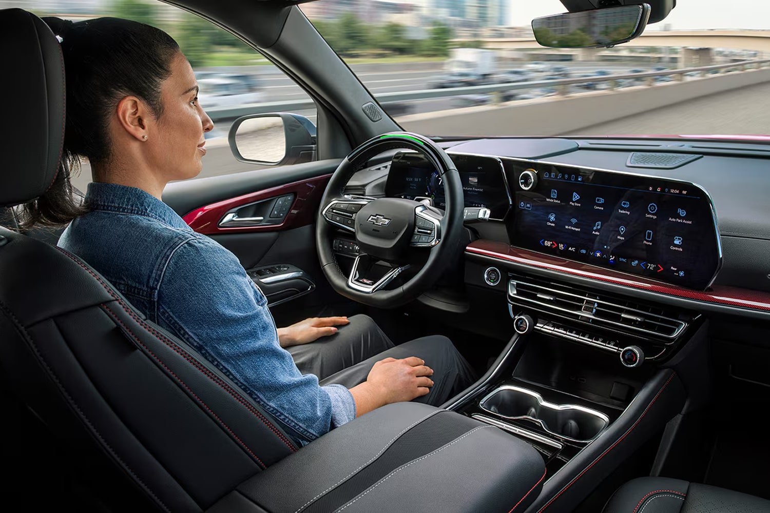 Passenger Seat View of a Woman Driving a Chevy Vehicle While Utilizing Super Cruise on a Highway