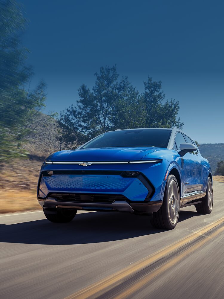 A Chevy Equinox EUV Driving Down a Mountain Road with Text Overlay Reading "Experience It Yourself. Test Drive a Super Cruise Enabled Vehicle at Your Local Chevrolet Dealer. It's Driver Assistance Technology that Helps Add Ease and Comfort to Your Drive."