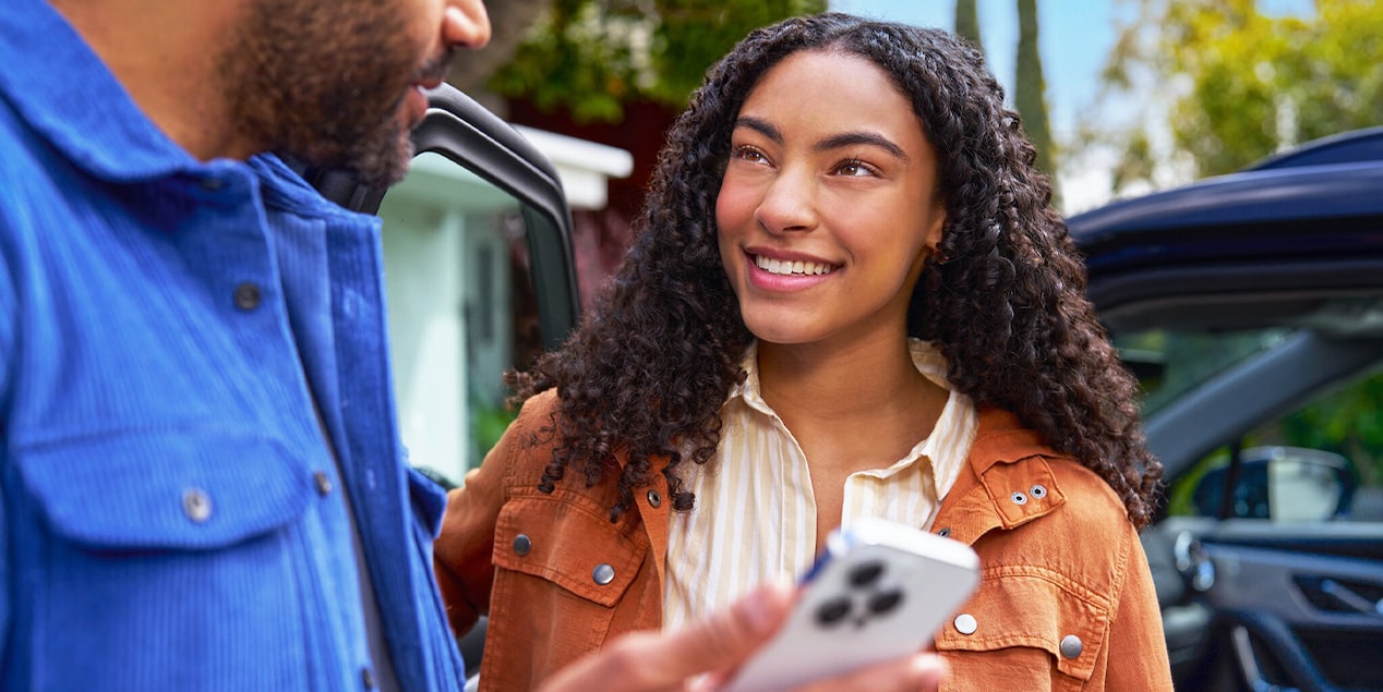 Couple Using the MyChevrolet App on Their Smartphone