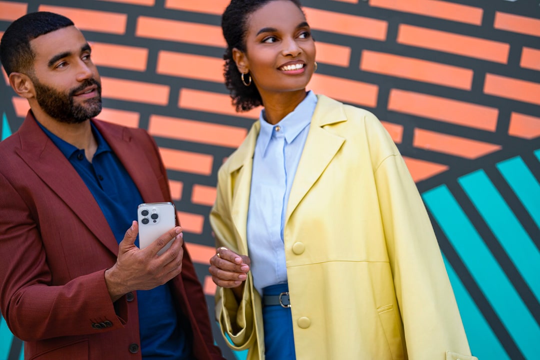 A Couple Looking Off Into The Distance While Holding a Smartphone