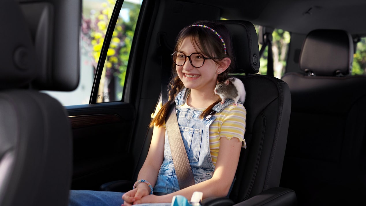 Little Girl Sitting in Second Row Seating While Buckled In