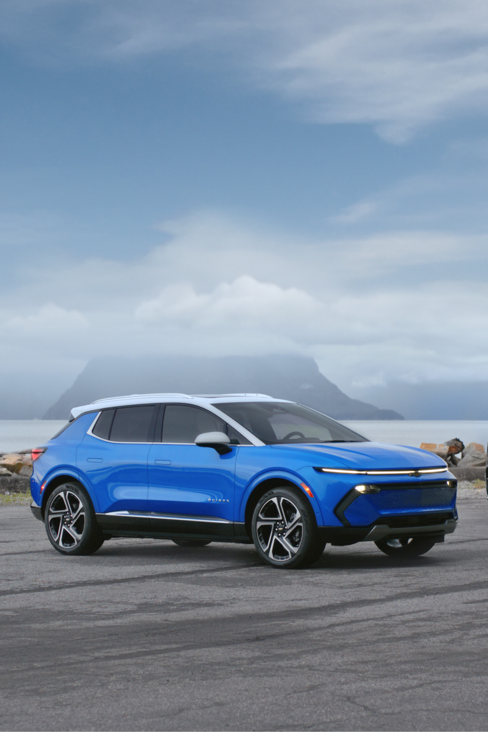 Chevy EV Lineup Parked in Front of a Misty Lake: Blazer EV, Equinox EV, Silverado EV
