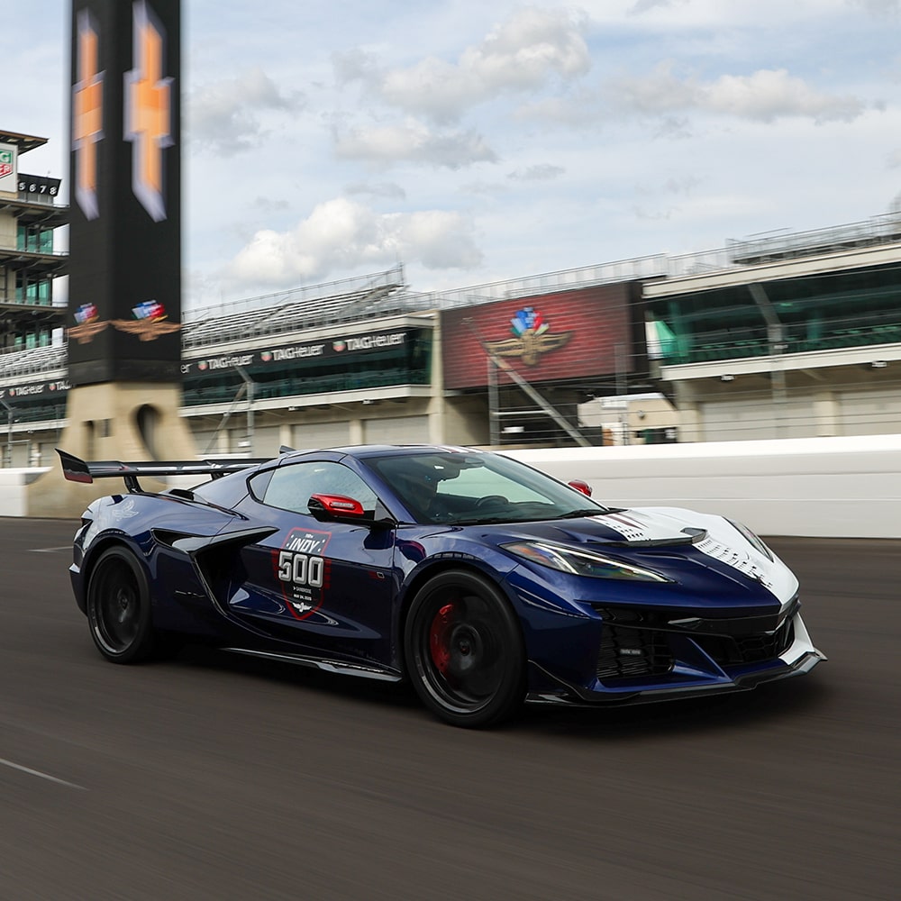 Three-quarter View of a Dark Blue and White Chevy Corvette ZR1X with the Side Reading "Indy 500" Speeding Down a Racetrack