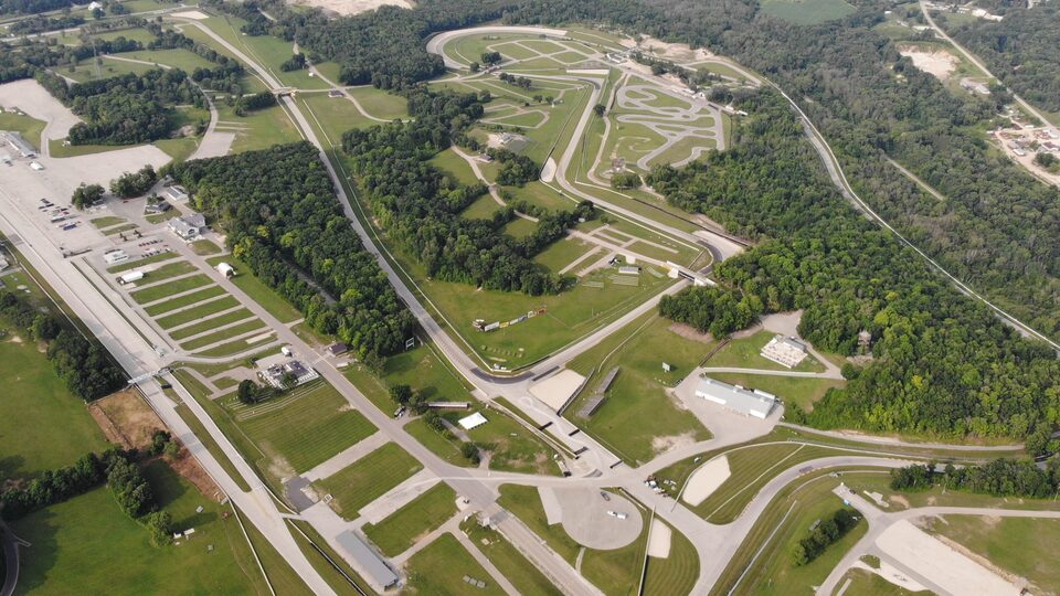 An bird’s-eye view of the entire Roadway America racetrack and grounds in Wisconsin. The words “New Roads” appear over the image.