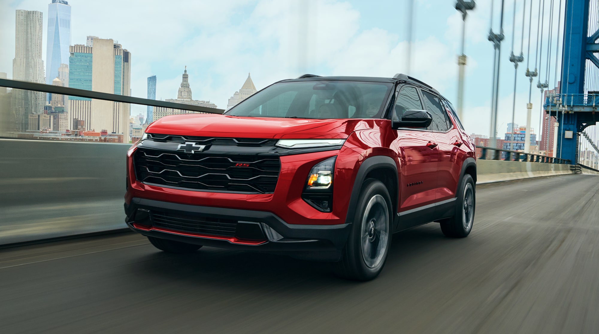 A Red 2027 Chevy Equinox Driving Through a Bridge Outlooking the City