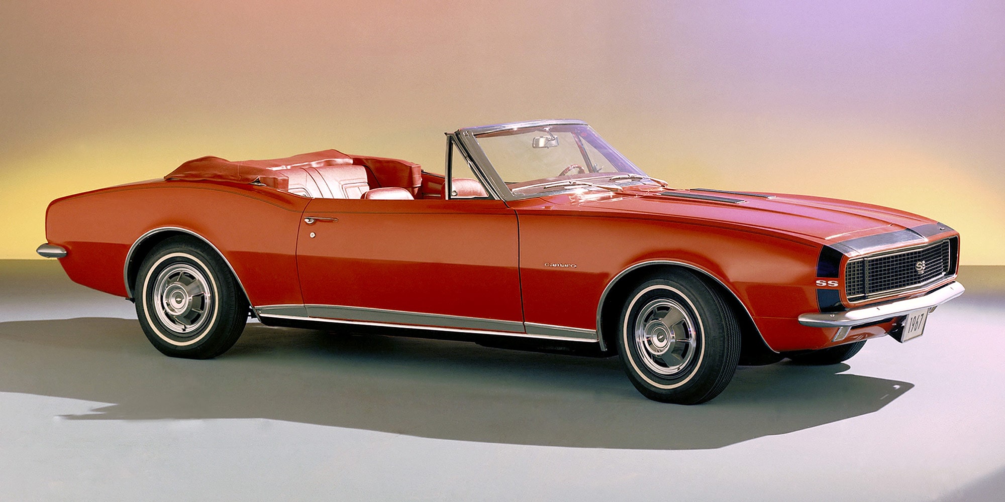 Vintage Red Convertible Car in a Studio Setting with a Soft Gradient Background