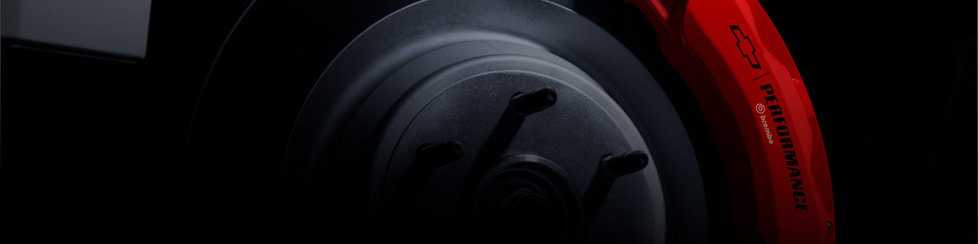 Close-up of a Brake Rotor with the Chevrolet Logo Next to It