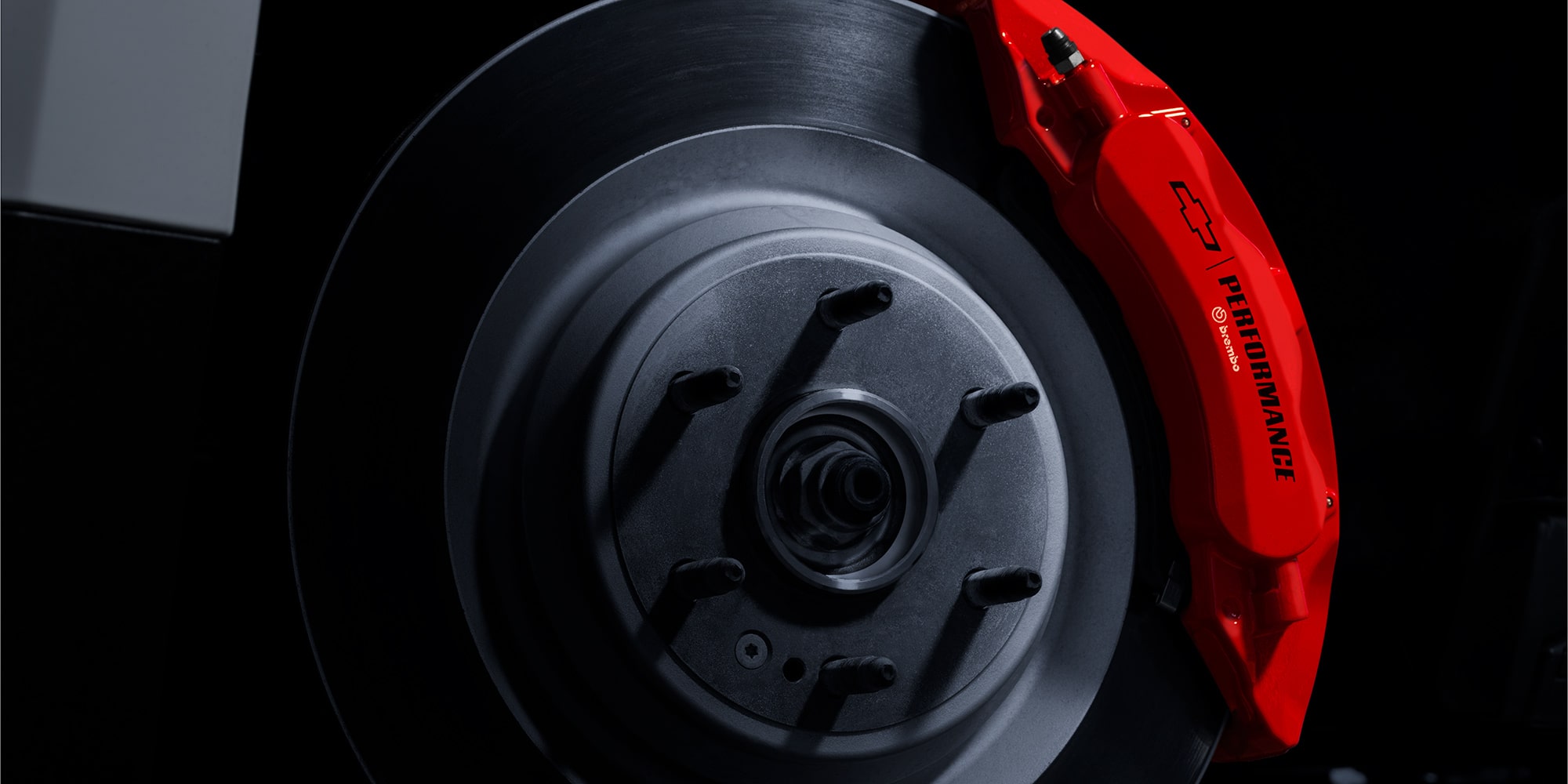 Close-up of a Brake Rotor with the Chevrolet Logo Next to It