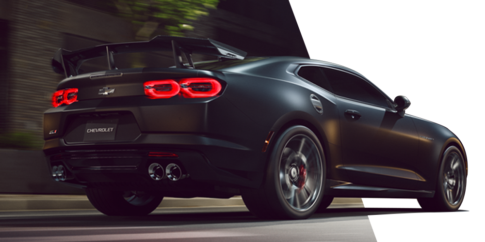 Matte Black Chevy Camaro with a Large Rear Wing Driving Down a Road with Red Taillights Glowing