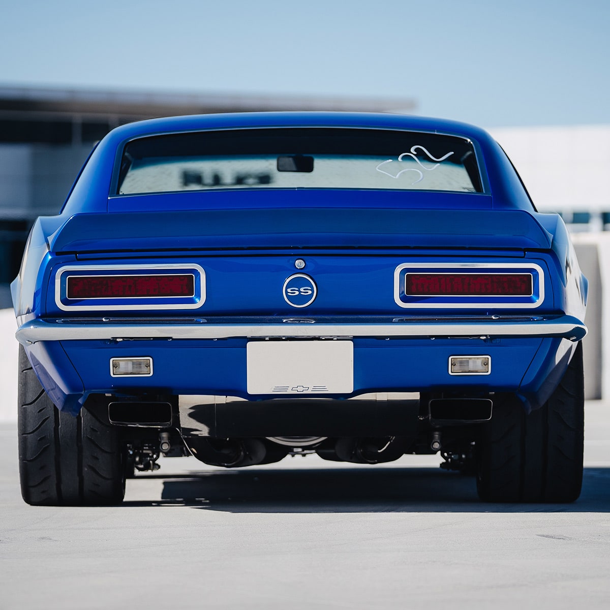 Rear View of a Bright Blue Classic Chevy Camaro Ss Parked on a Pavement