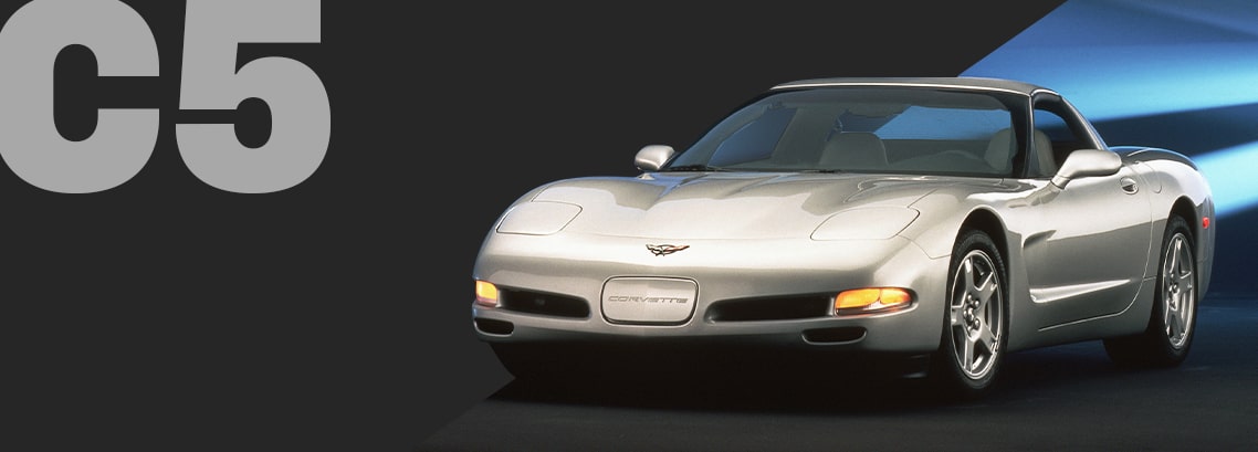 A Silver Chevrolet Corvette C5 Convertible Shown From the Front on a Black Background With Large Gray Text Reading “C5.”