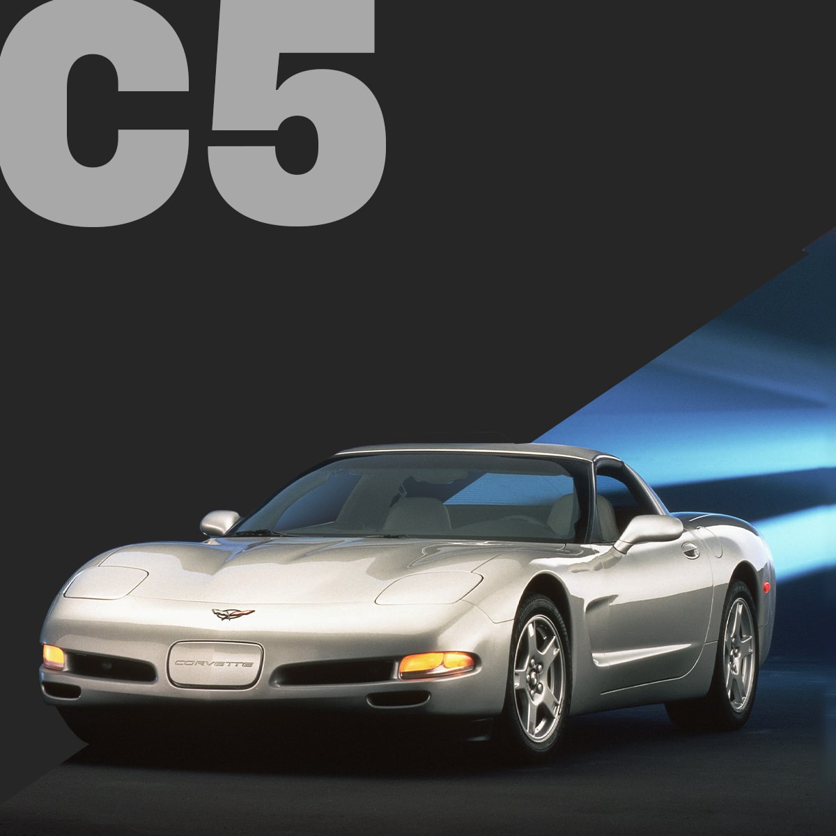 A Silver Chevrolet Corvette C5 Convertible Driving Forward With a Blue Light Streak Behind It on a Black Background With Large Gray Text Reading “C5.”