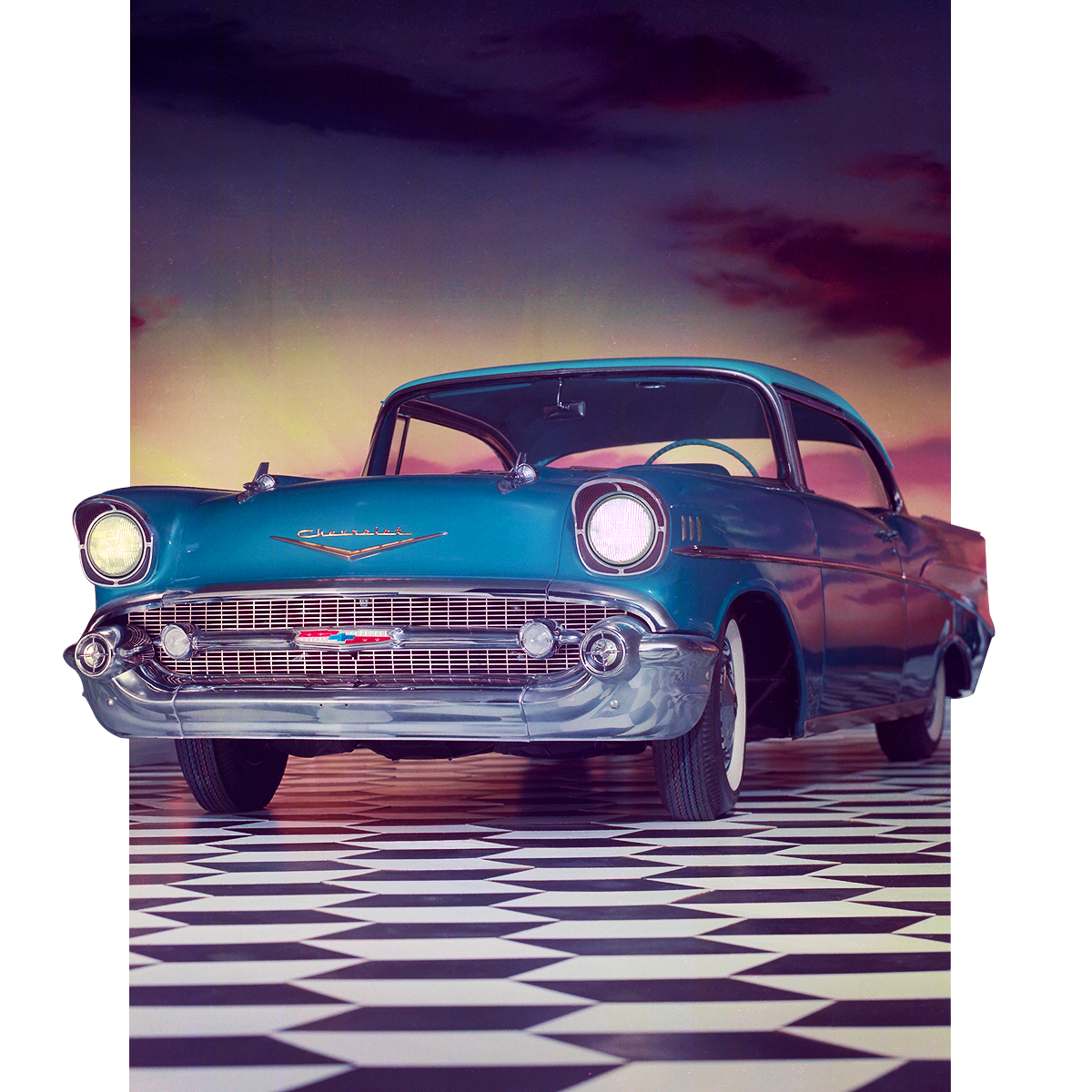 Classic Teal Chevrolet Bel Air Coupe on a Black-And-White Checkered Floor with Sunset Sky in the Background