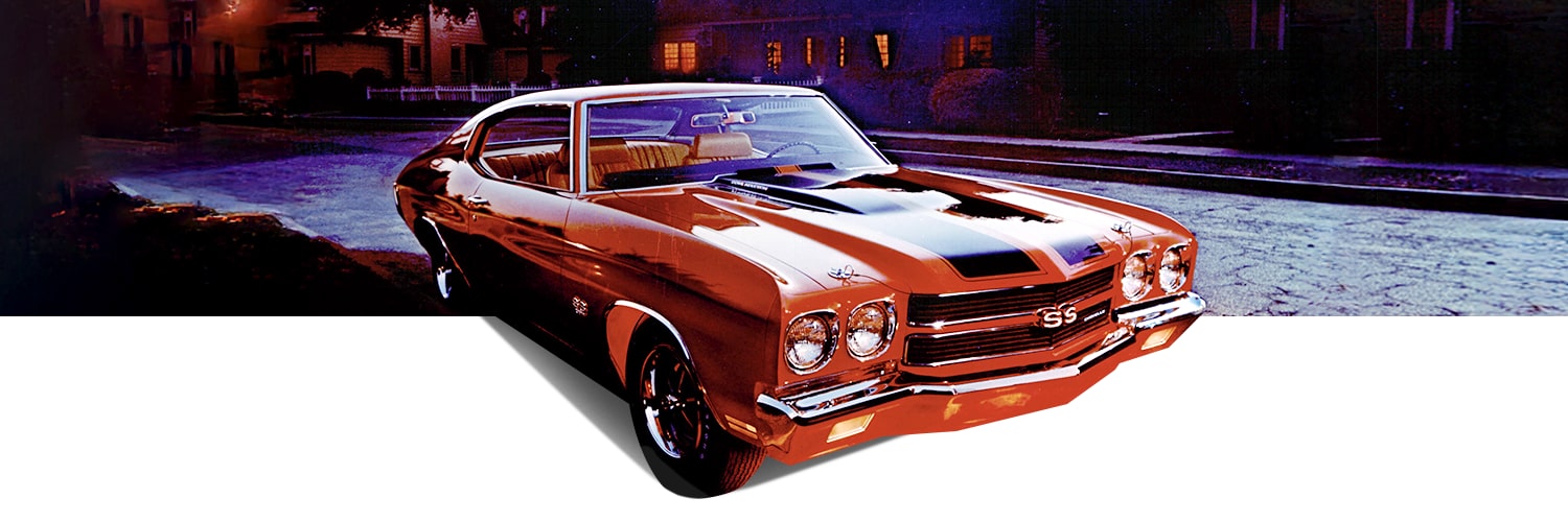 Front Three Quarters View of a Classic Orange Chevrolet Chevelle Vehicle with Black Racing Stripes Parked on a Road