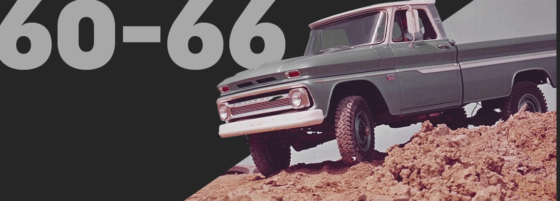 Vintage Blue Chevrolet Pickup Truck Driving on Rugged Terrain