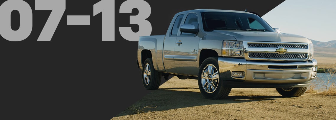 Front Three-Quarter View of a Silver Chevrolet Pickup Truck Parked Off-road