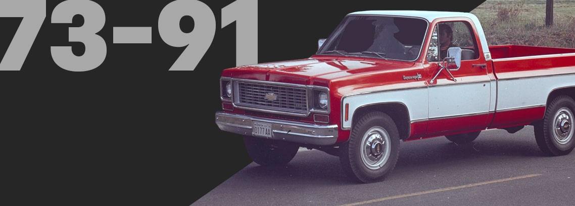Red and White Classic Chevrolet Pickup Truck Driving on a Rural Road